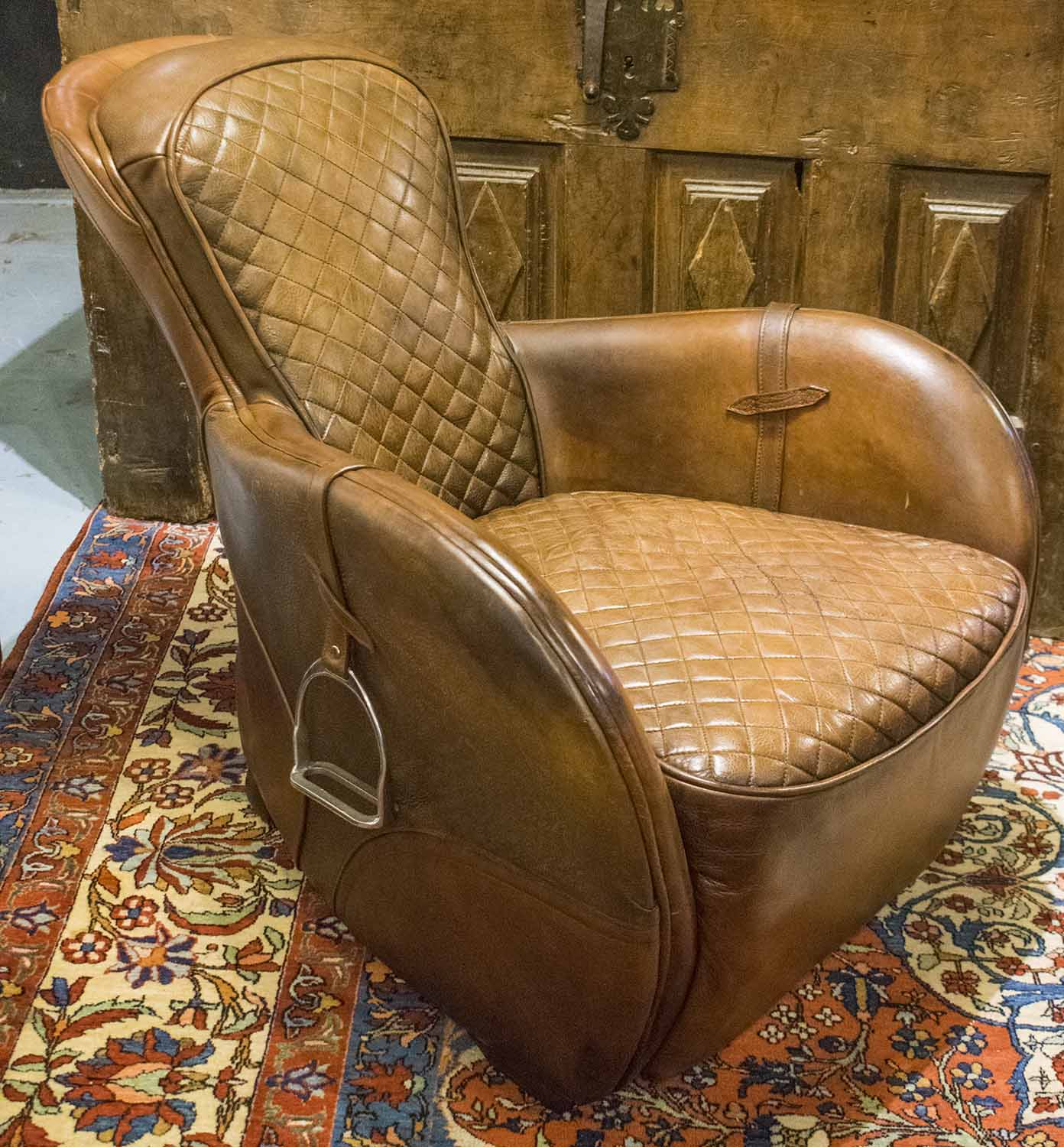 TIMOTHY OULTON SADDLE CHAIR, quilted stitched leather seat and back padded arms and stirrups, 77cm.