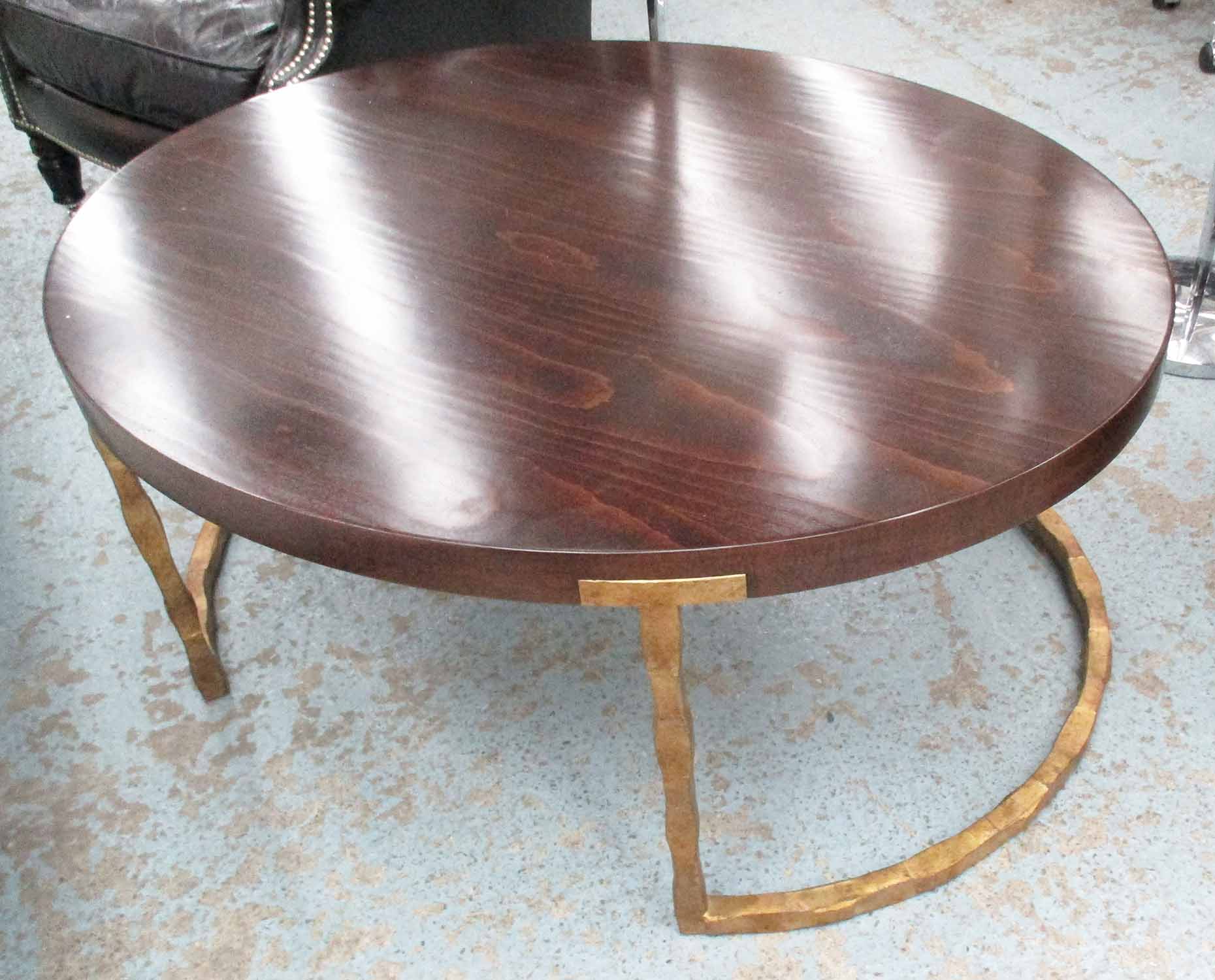 PORTA ROMANA LOW TABLE, oval wooden top, on a brass effect metal base, 106cm L x 89cm D x 45cm H.