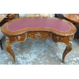 KIDNEY SHAPED BUREAU PLAT, Louis XV style with gilt mounts and oxblood top.