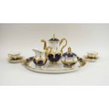 CONTINENTAL CERAMIC CABARET SET, blue, white and gilt, comprising tray, coffee pot, milk jug,