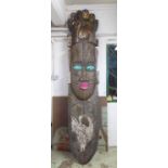 WEST AFRICAN TOTEMIC WALL CARVING, metal clad with painted and cowrie shell detail,