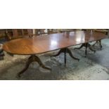 DINING TABLE, Georgian style mahogany with rounded ends on triple pedestals and brass castors,