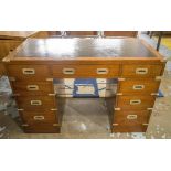 CAMPAIGN STYLE DESK, mahogany and brass bound with nine drawers, twin pedestals and tooled leather,