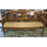 FRENCH COUNTRY BENCH, mid 19th century French, walnut with scroll arms and rush bench seat, 177cm W.