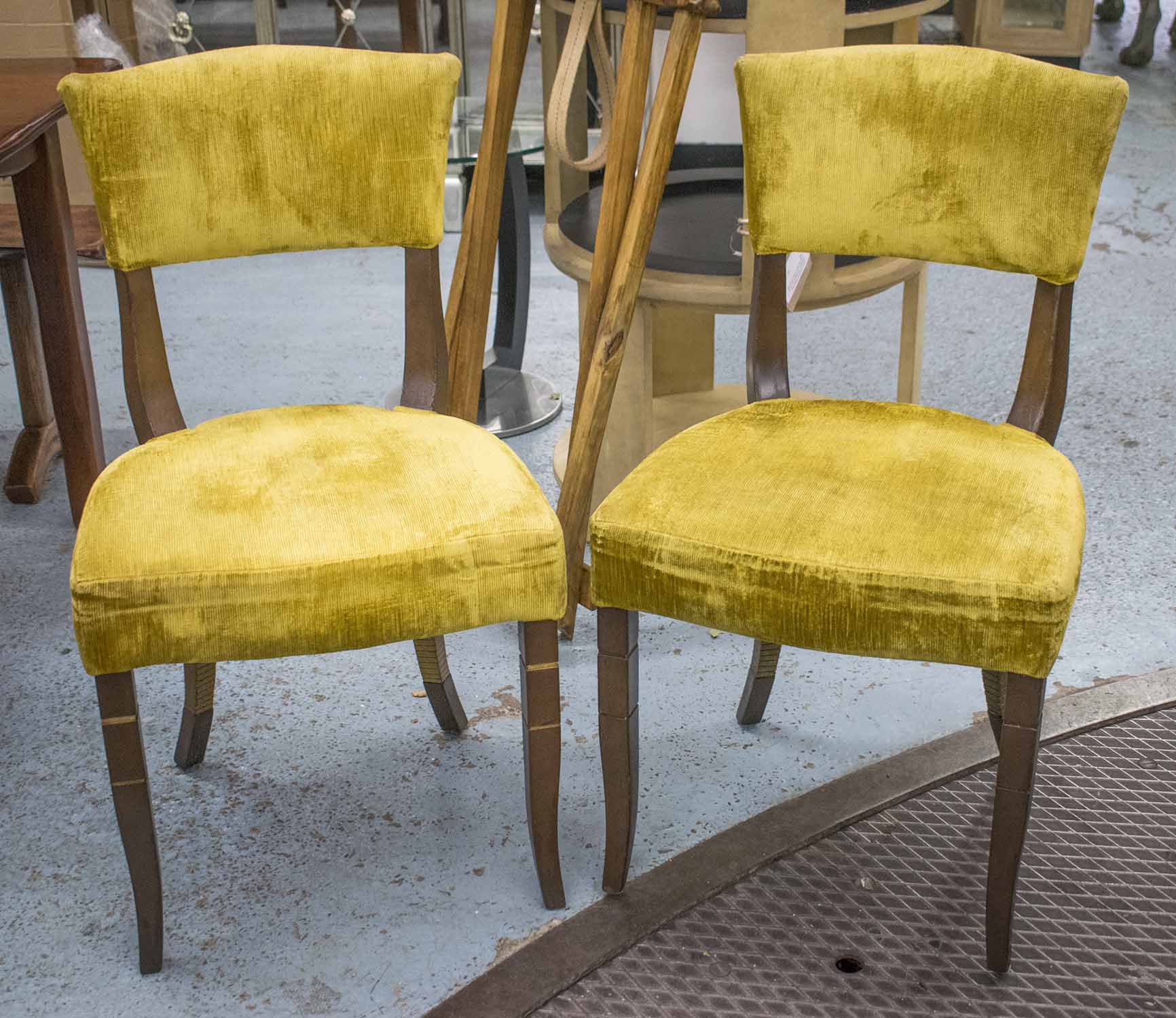 DINING CHAIRS, a set of ten, Art Deco style with gilt detail and yellow velvet cord upholstery.