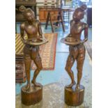 STANDS, a pair, Indonesian carved hardwood modeled as figures with trays, 122cm H.