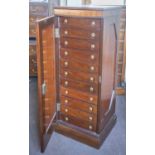 COLLECTORS CHEST, Victorian mahogany with panel door enclosing eleven drawers,