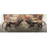 BRONZE LIONS, a pair, 45cm W x 24cm H.