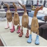 WOODEN 'RUNNER DUCKS', a set of four, carved natural wood, with boots, polished finish, 43cm H.