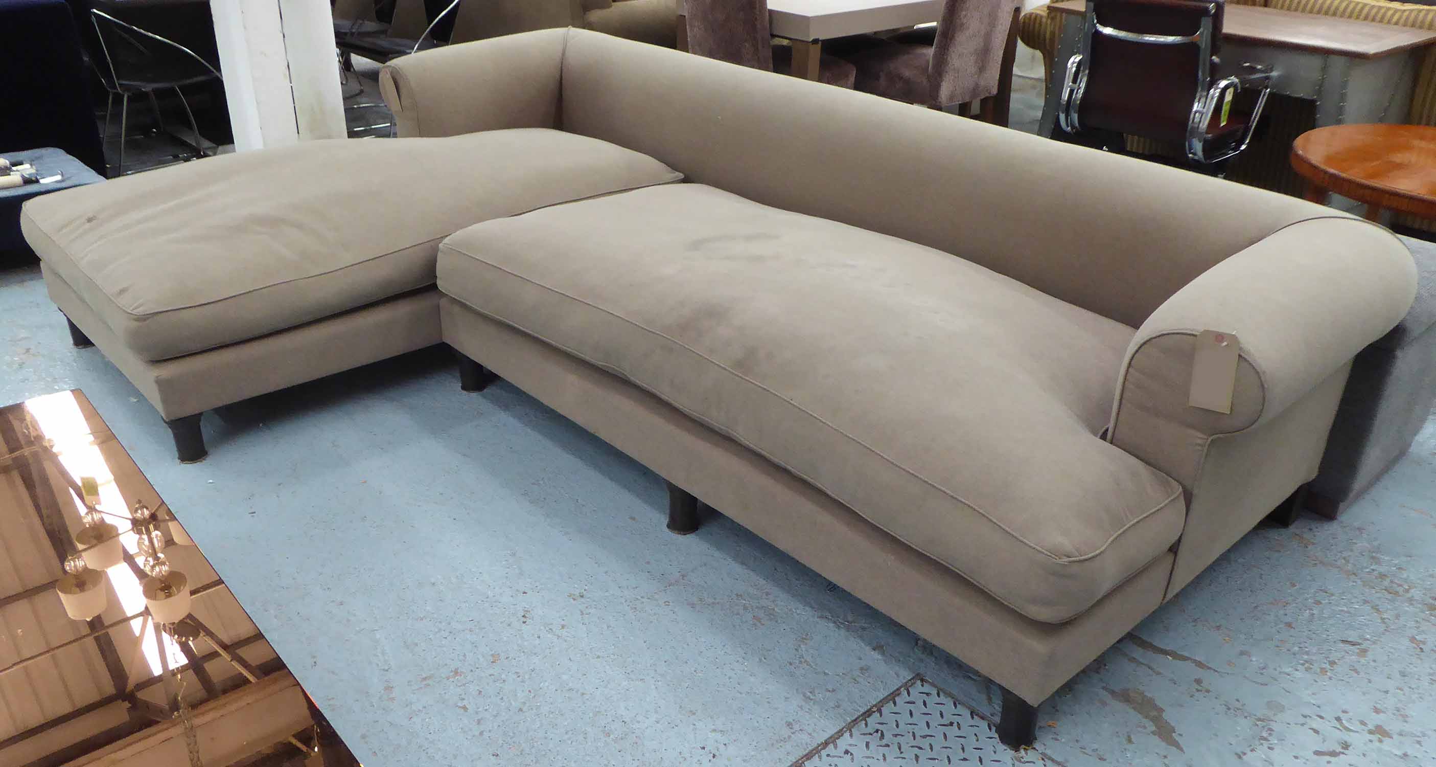 CORNER SOFA, in a beige fabric on turned supports, 285cm x 188cm.