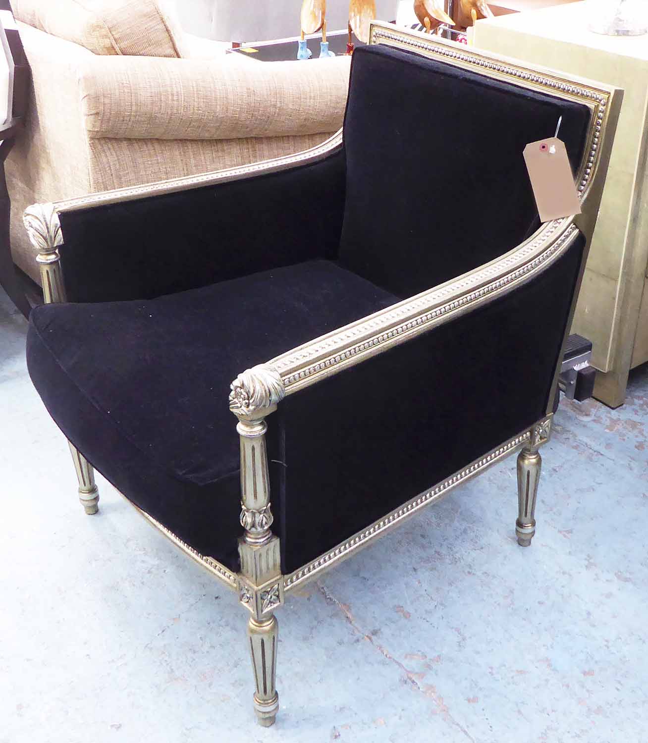 ARMCHAIR, French Empire style with beaded and carved silver gilt showframe, in black upholstery,