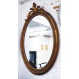 OVAL MIRROR, with bevelled plate in a gilded frame.
