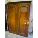 WARDROBE, Victorian mahogany with two arched panelled doors enclosing double hanging.