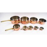 SET OF NINE GRADUATED COPPER PANS, largest 20.5cm diam.