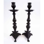 PAIR OF 19TH CENTURY BRONZE CANDLESTICKS, with baluster knopped stems, triform bases and paw feet,