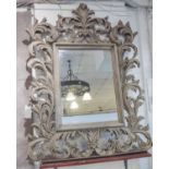 WALL MIRROR, Florentine style with a rectangular bevelled plate and leaf and scroll decoration,