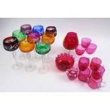COLOURED GLASSWARES, including nine hock glasses and various cranberry coloured glasses and cups.