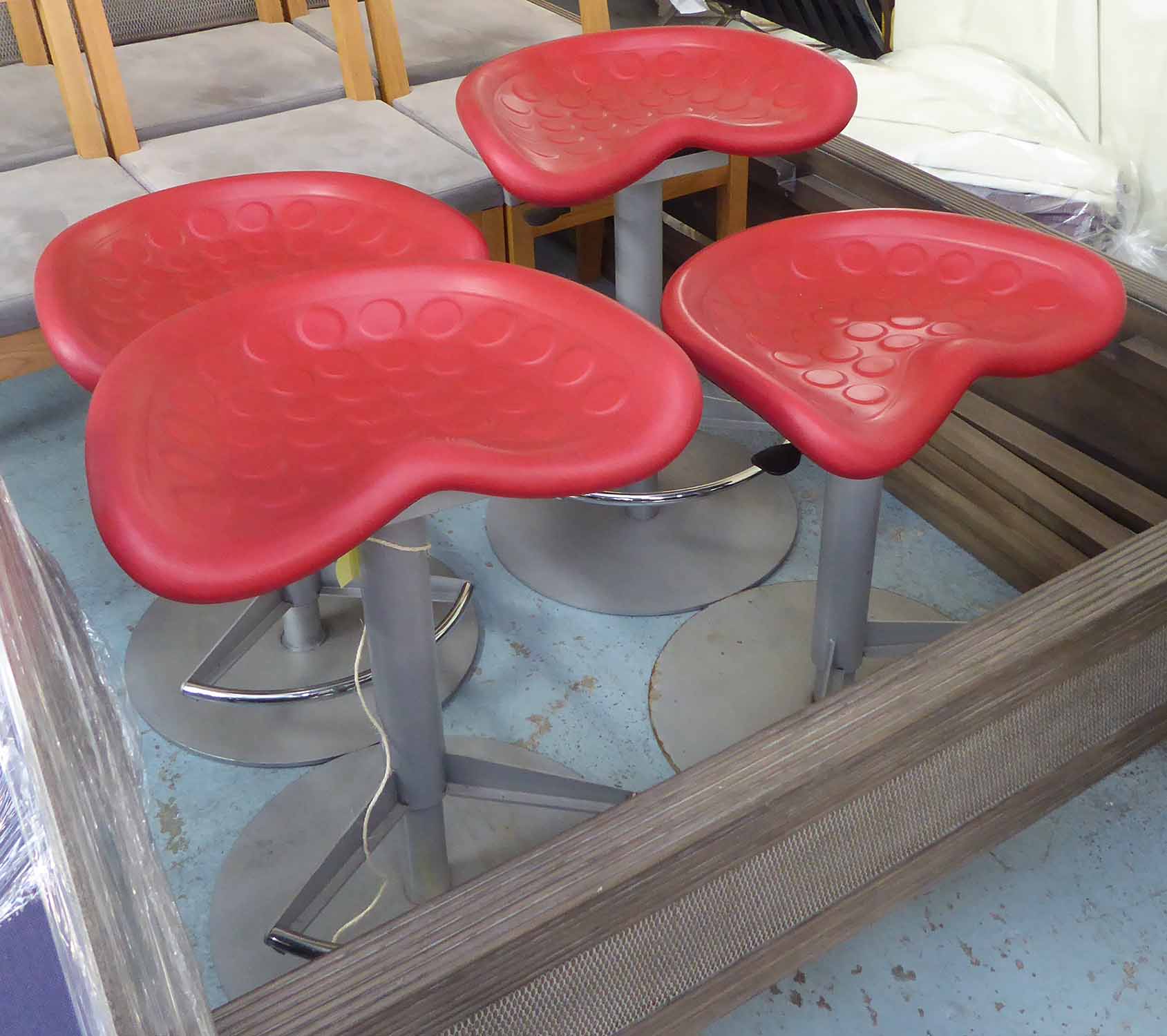 BAR STOOLS, a set of four, adjustable, red tractor style seats.