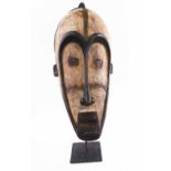WEST AFRICAN FANG PEOPLE FACE MASK, carved and painted wood, approx 52cm L with display stand.