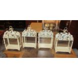 GARDEN LANTERNS, a set of four, each with flowerhead decoration and glazed panels, 41cm H.