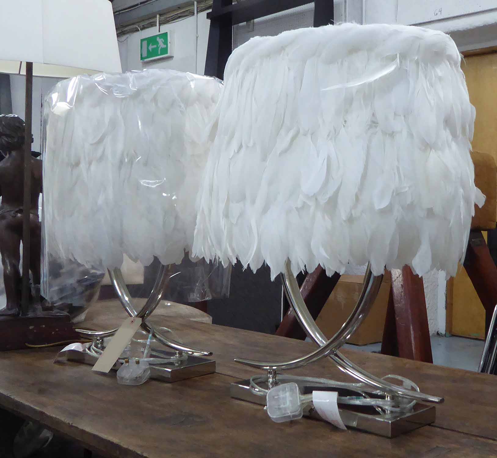 TABLE LAMPS, a pair, twin branch, chromed metal base and white feathered shades, 62cm H.