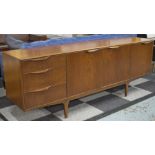 SIDEBOARD, 1970s, teak, with drawers and cupboards on slender supports, labelled 'A.H.
