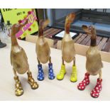 WOODEN 'RUNNER' DUCKS, a set of four, carved natural wood, coloured boots, polished finish, 45cm H.