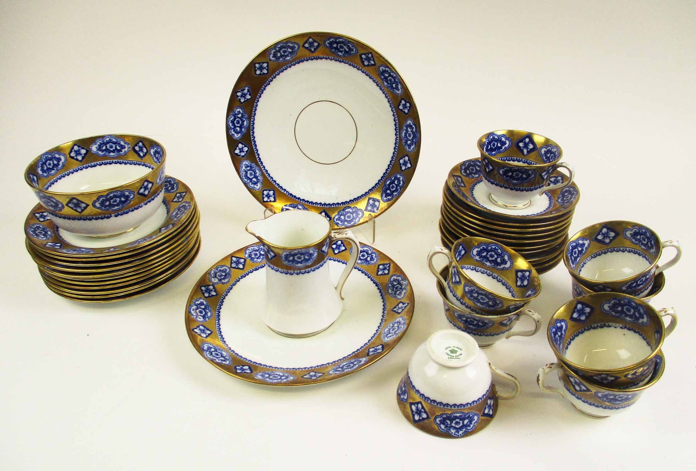 PRINCE ALBERT CROWN CHINA PART TEA SERVICE, blue and gilt band decoration.