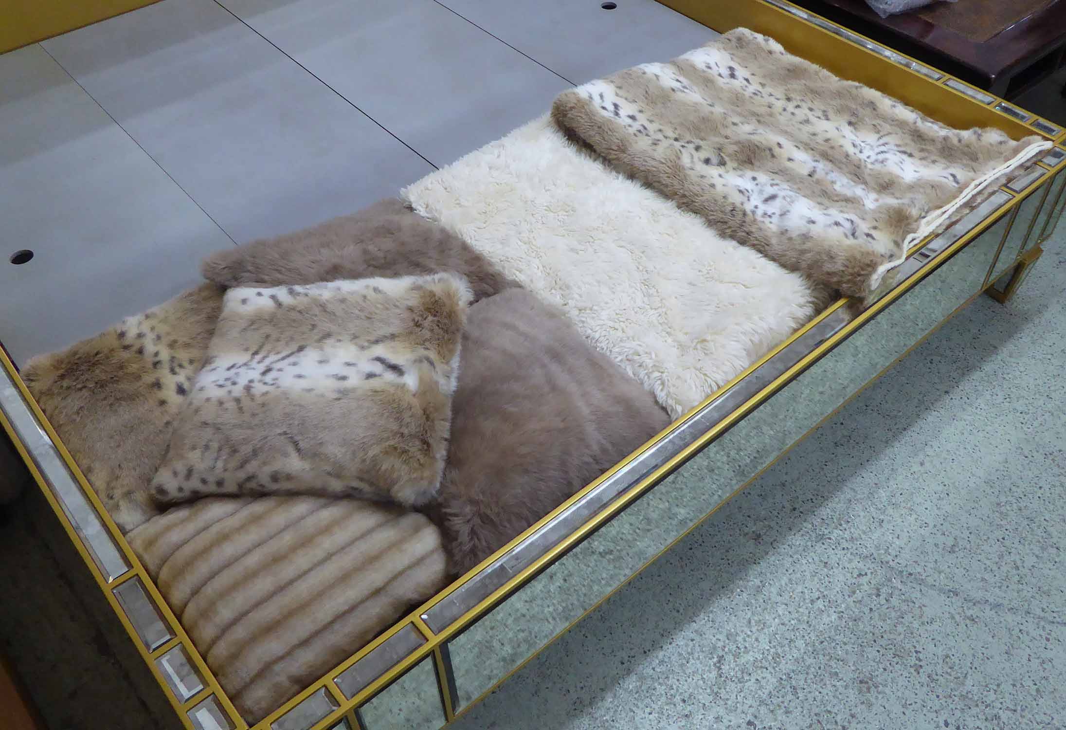 TWO FAUX FUR THROWS, plus five faux fur cushions.