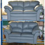 2 PIECE GREEN LEATHER LOUNGE SUITE COMPRISING 2 X 2 SEATER SETTEES