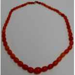 A STRING OF 53 GRADUATED ART DECO BUTTERSCOTCH AMBER COLOURED BEADS - APPROXIMATE WEIGHT = 50 GRAMS