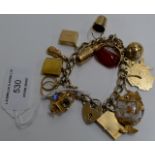 13 VARIOUS 9 CARAT GOLD CHARMS INCLUDING A MASONIC CHARM, MOUNTED ON A STERLING SILVER GILT BRACELET