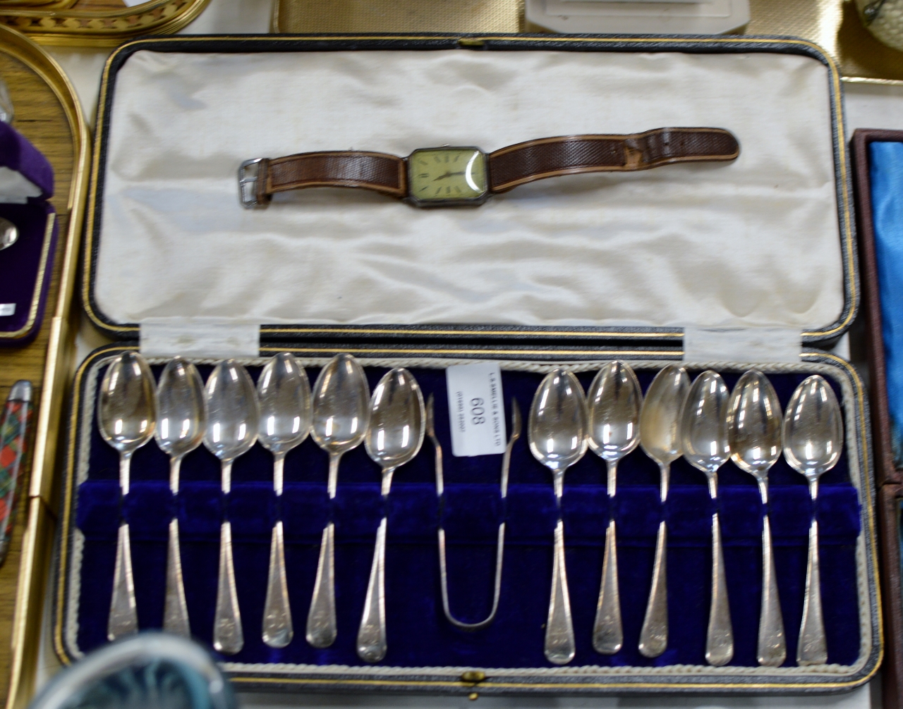 CASED SET OF 12 SHEFFIELD SILVER TEASPOONS WITH TONGS & OLD SILVER CASED WRIST WATCH ON LEATHER