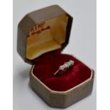 A LADIES TRIPLE STONE DIAMOND RING SET ON GOLD BAND (GOLD UNMARKED)