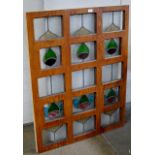 AN OAK FRAMED SECTIONAL 10 PANEL STAINED GLASS WINDOW DISPLAY