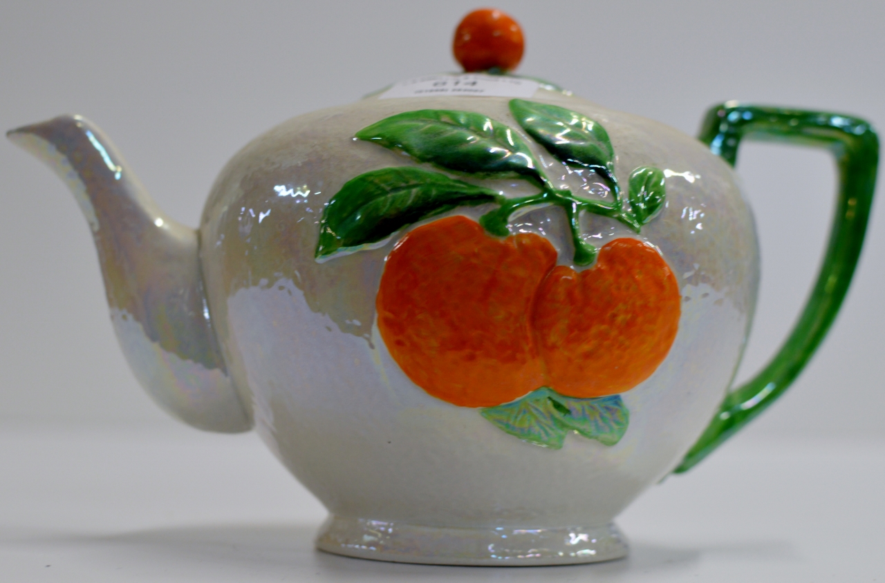 A CARLTON WARE LUSTRE FINISHED TEAPOT WITH ORANGE FRUIT DESIGN IN RELIEF