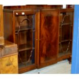 A 54½" MAHOGANY TRIPLE DOOR BOOKCASE ON QUEEN ANNE LEG