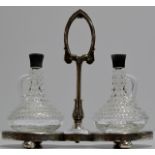 AN ORNATE ART NOUVEAU EPNS DECANTER STAND WITH PAIR OF DECANTERS WITH STOPPERS