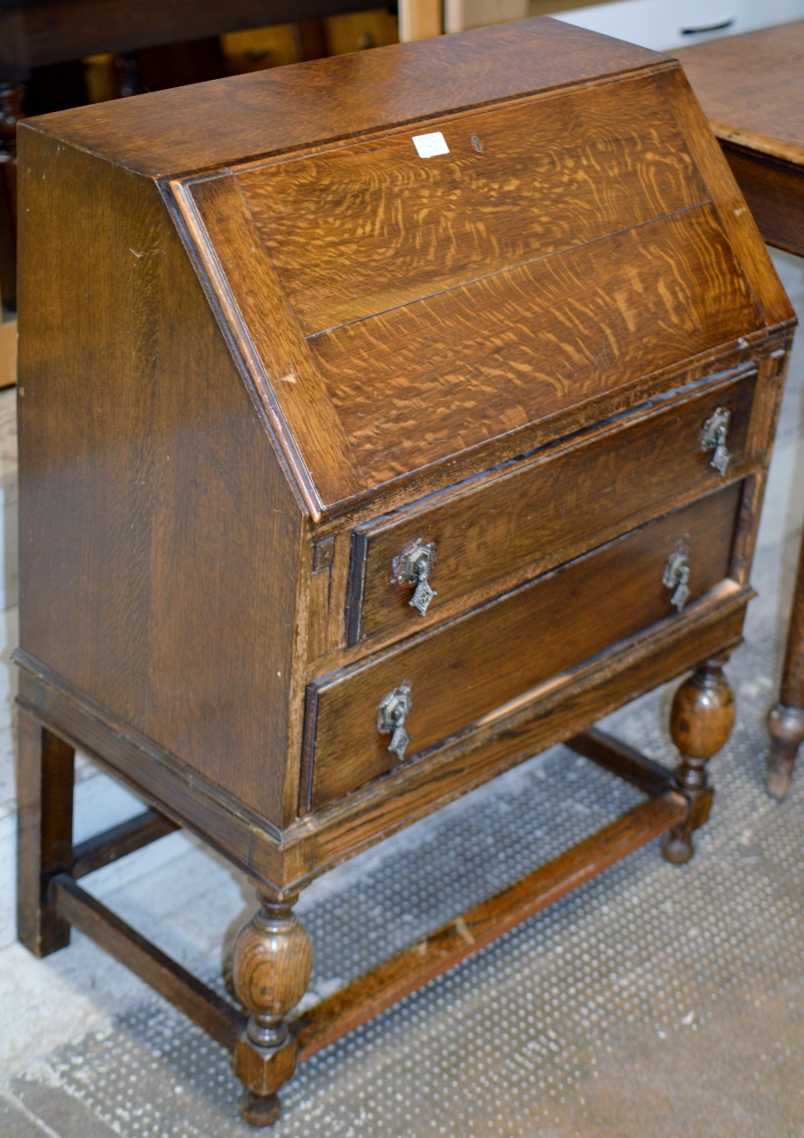 AN OAK WRITING BUREAU OVER 2 DRAWERS ON STRETCHER BASE