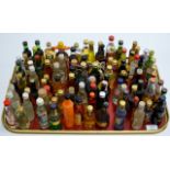 A TRAY WITH 100 VARIOUS ALCOHOL MINIATURES