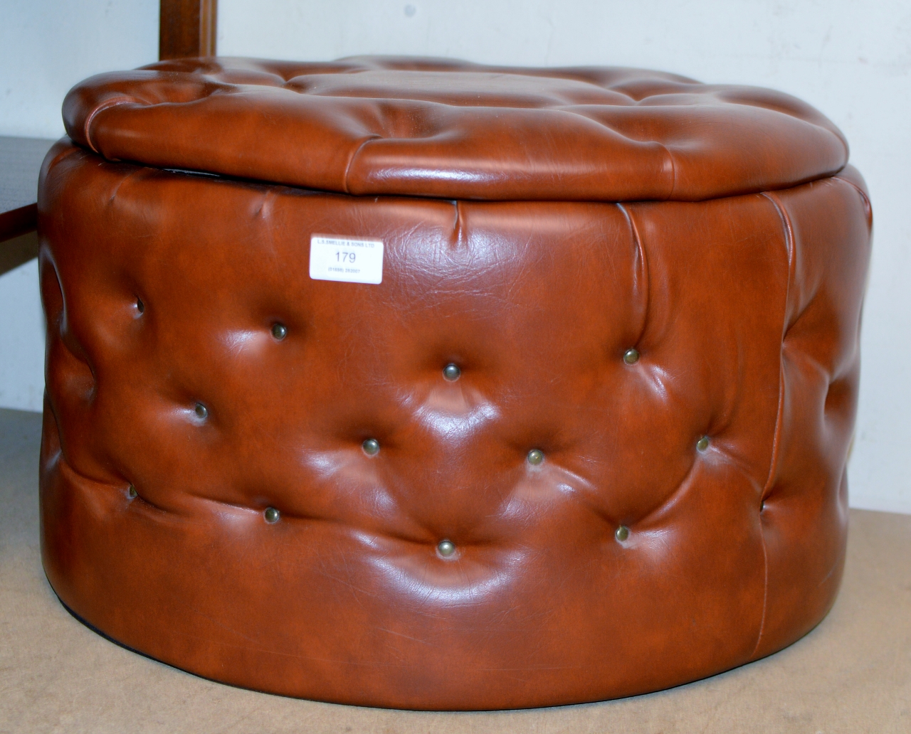 A VINTAGE PADDED LEATHER EFFECT STORAGE FOOT STOOL