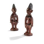 YORUBA IBEJI TWIN FIGURES carved wood, male and female, each with incised domed coiffure and