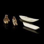 PAIR OF INUIT FIGURES AND CANOES comprising two carved wood figures in sealskin coats and a pair