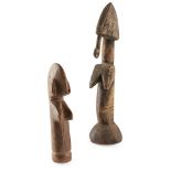 PAIR OF MOSSI DOLLS carved wood, the larger example with rounded beard, incised decoration to the