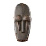 BAMANA MASK carved wood, shown with wide eyes, open mouth and long vertical incisions below each