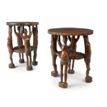 PAIR OF EAST AFRICAN TABLES wood, the circular tops each held up by four finely carved figures