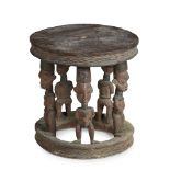 BABANKI CHIEF'S STOOL carved wood and pigment, the ringed base supporting five figures with circular