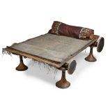 TUAREG BED wood, camel leather and reed, consisting of; four wooden stands, a head & base pole