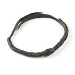 IGBO TORQUE 800 - 1000 AD patinated bronze with a central interlocking reserve, on a twist form