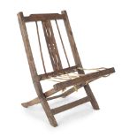 SAFARI CHAIR carved wood, leather strips and metal rivets, a classic early 1920's fold-out safari